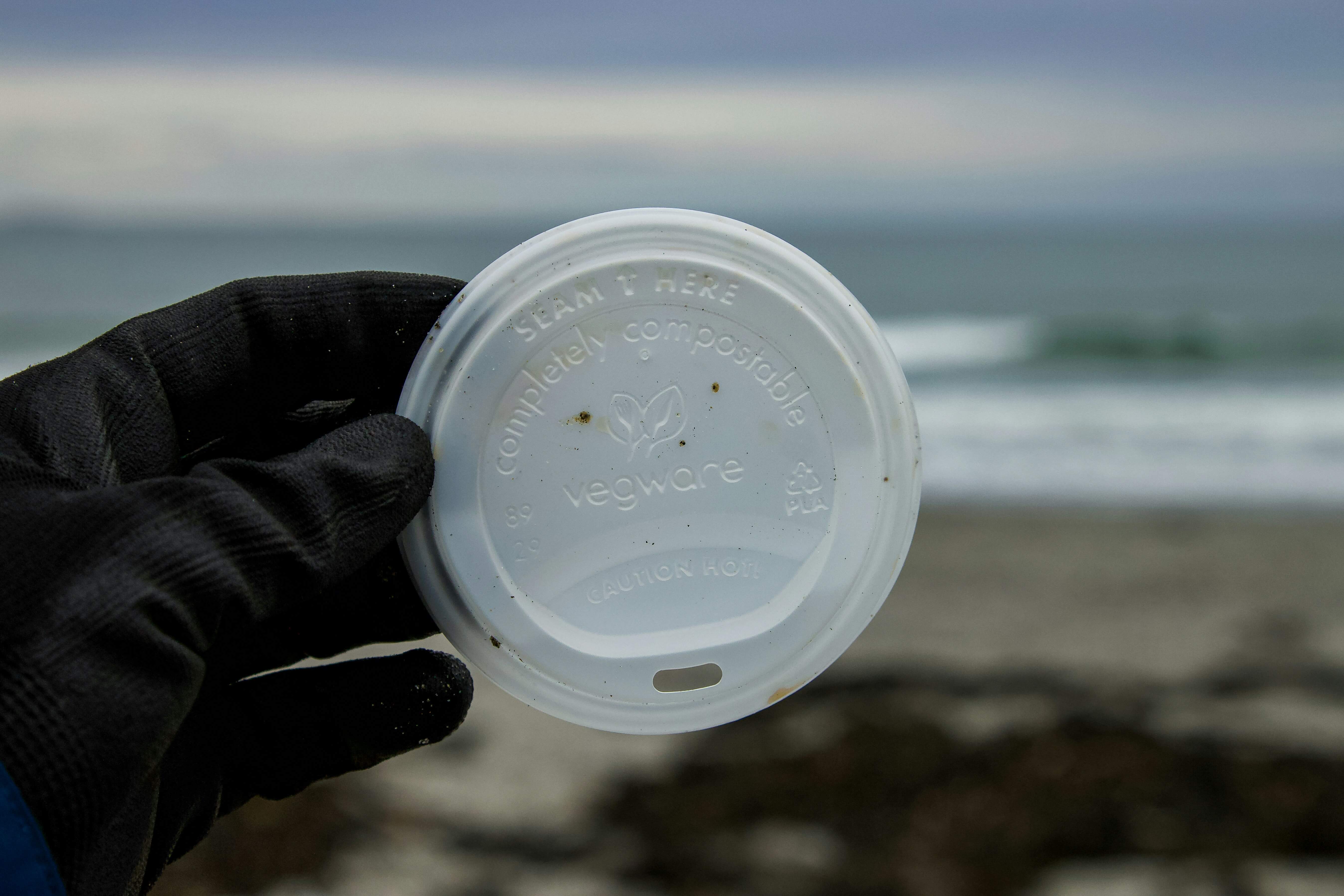 Plastic coffee cup rubbish on a beach