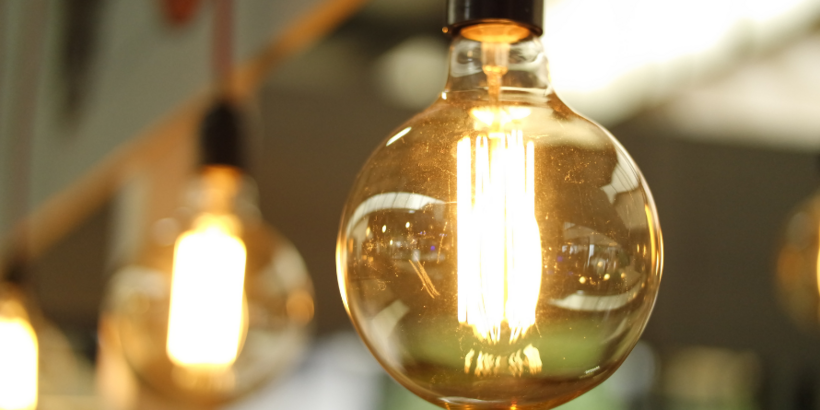 Close-up of a glowing round electric light bulb